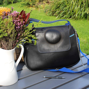 Recycled rubber handbag with puncture repair feature and blue strap